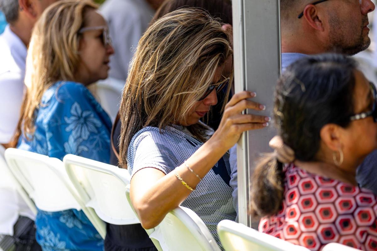 A woman cries from her seat during the Second Annual Remembrance Ceremony of the Champlain Towers South building collapse at Veterans Park on Saturday, June 24, 2023, in Surfside, Florida.