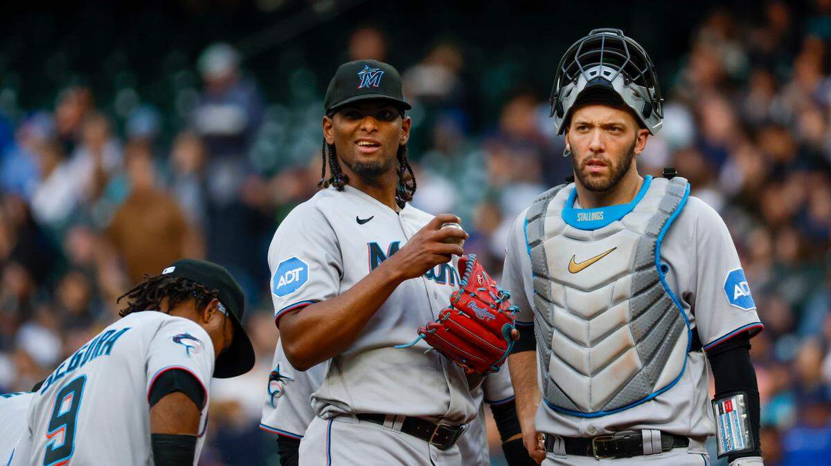 Jun 13, 2023; Seattle, Washington, USA; Miami Marlins starting pitcher Edward Cabrera (27) receives a mound visit from catcher Jacob Stallings (58) and third baseman Jean Segura (9) during the fourth inning against the Seattle Mariners at T-Mobile Park. Mandatory Credit: Joe Nicholson-USA TODAY Sports