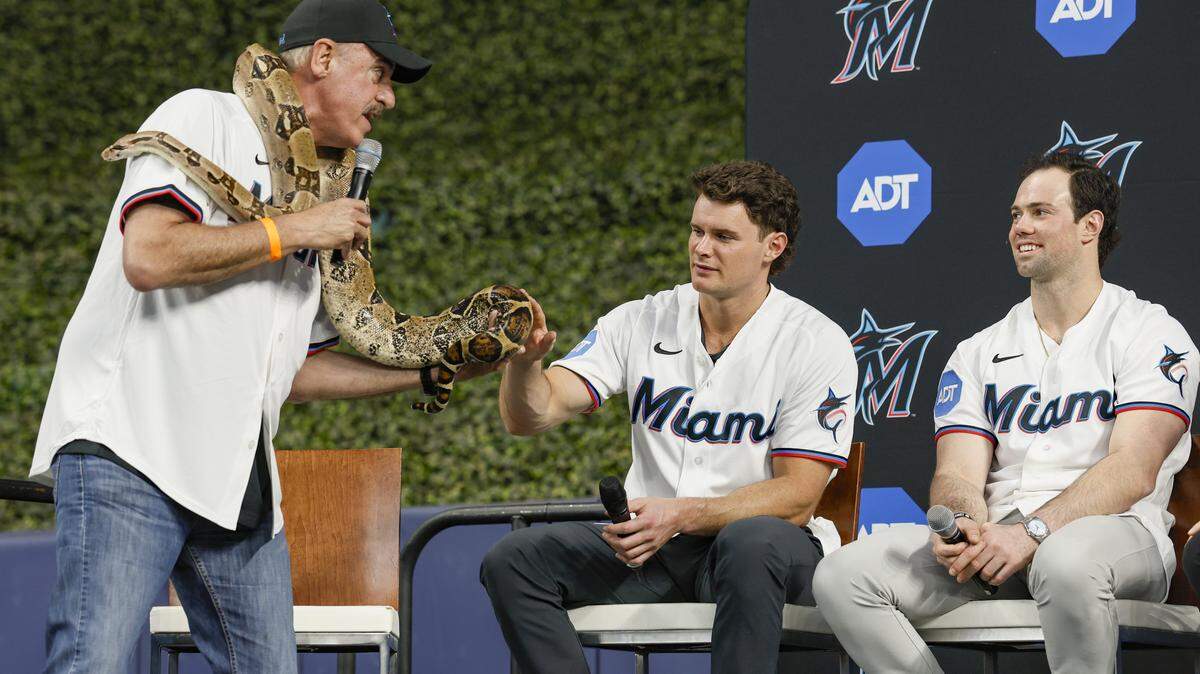 Ron Magill, communications director of Zoo Miami, shows Miami Marlins players Griffin Conine and Graham Pauley a python on stage during Marlins Fan Fest at  loanDepot park in Miami on Saturday, February 7, 2026. 
