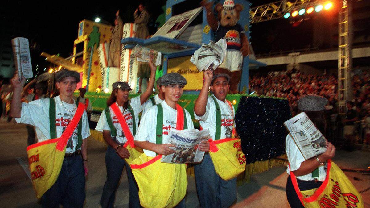 In this 1998 file photo, the Miami Herald float moves down Biscayne Boulevard with paper boys in the annual Orange Bowl Parade.