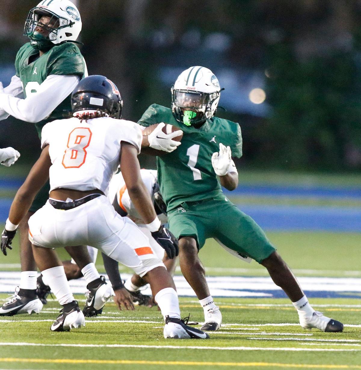 Miami Central running back Jayden Ford (1) tries to escape Lakeland High Damareion Smith (8) during season opener on Friday, August 23, 2024 at Traz Powell Stadium in Miami. Andrew Uloza / for Miami Herald