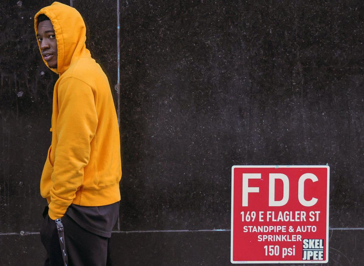Downtown resident Eric Jean-Francois, 25, dons a yellow hoodie during his morning walk as an Arctic blast hits Miami with temperatures in the low 50s and upper 40s in parts of South Florida on Jan. 8, 2025.