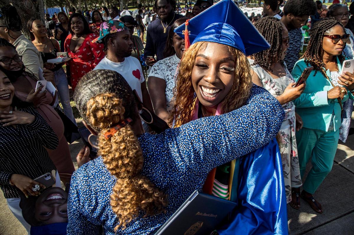 A relative greets student Creanne Alicia Butler, graduating with a Bachelor of Science in Aeronautical Science, during the Spring 2022 Commencement ceremony at Florida Memorial University in Miami Gardens, on Saturday May 14, 2022.