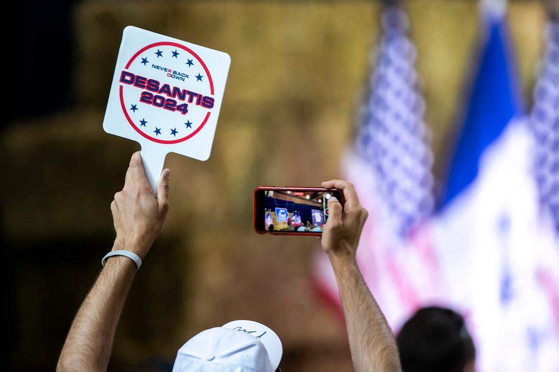 Supporters of Republican presidential candidate Florida Gov. Ron DeSantis hold fans during the annual Roast and Ride fundraiser for U.S. Sen. Joni Ernst, Saturday, June 3, 2023, at the Iowa State Fairgrounds in Des Moines, Iowa.
