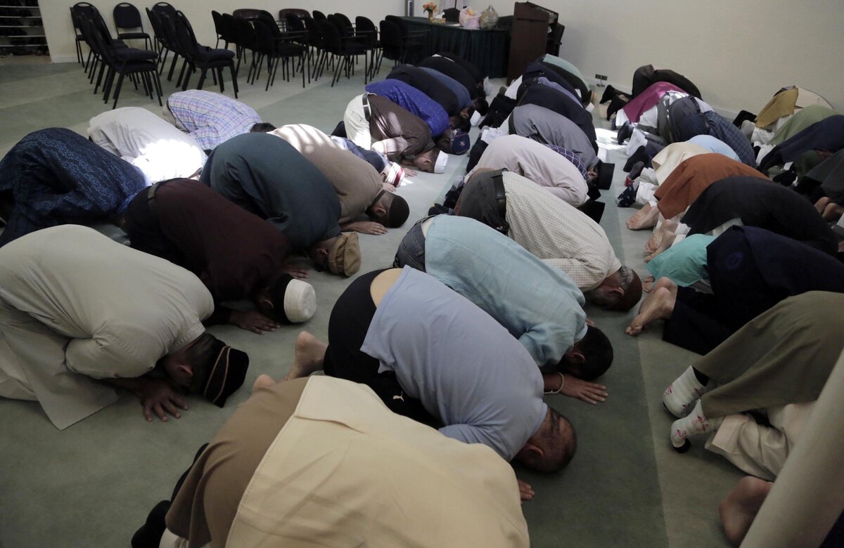 Members of the Baitul Naseer Mosque pray during services in celebration of Eid al-Fitr, the end of Ramadan.