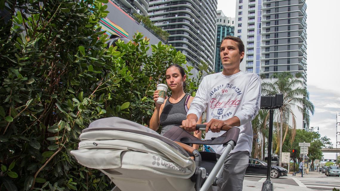 Brickell residents Krista and Charles Beuzelin take a walk with their newborn child around the neighborhood in Miami on Monday, May 28, 2018.