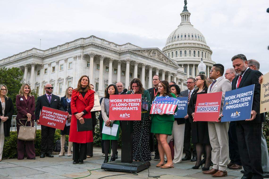 Angela Della Valle, surrounded by lawmakers and business leaders in Washington, D.C., pleads for immigration officials to release her husband, who has been detained for nine months.