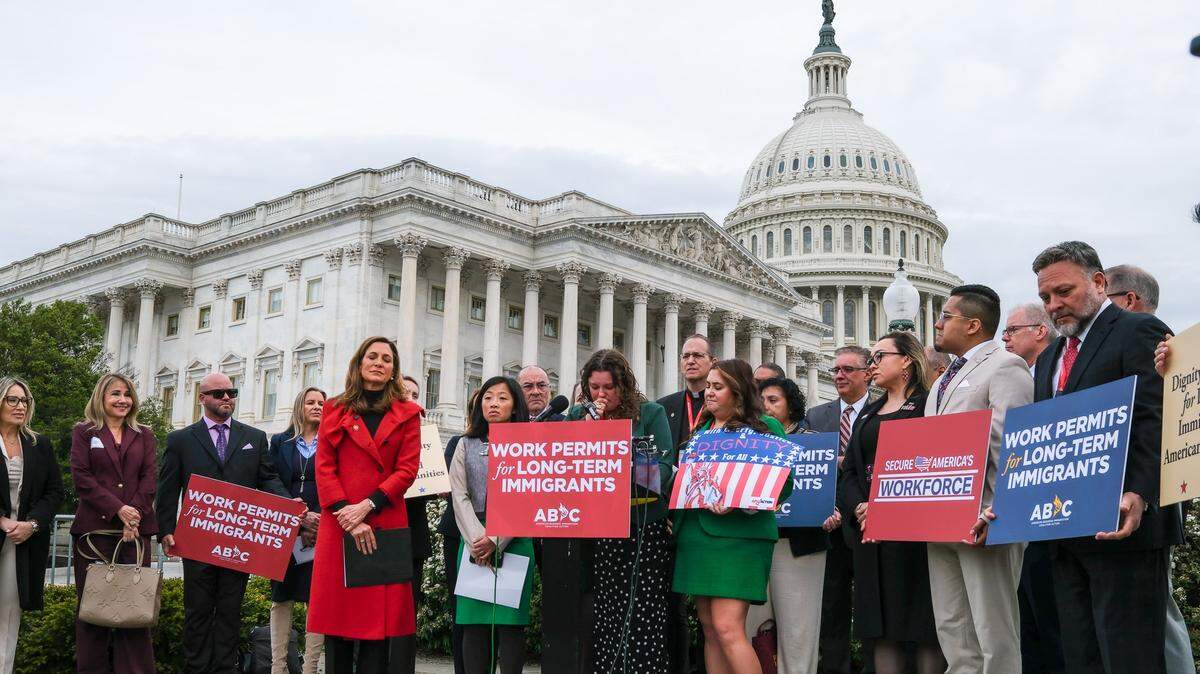 Angela Della Valle, surrounded by lawmakers, business and community leaders in Washington, D.C., pleads for immigration officials to release her husband, who has been detained for nine months.