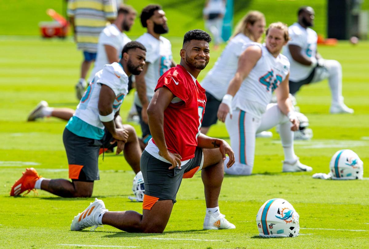 Miami Dolphins quarterback Tua Tagovailoa (1) stretches alongside teammates during the second day of mandatory mini camp at Baptist Health Training Complex in Miami Gardens, Florida, on Thursday, June 2, 2022.