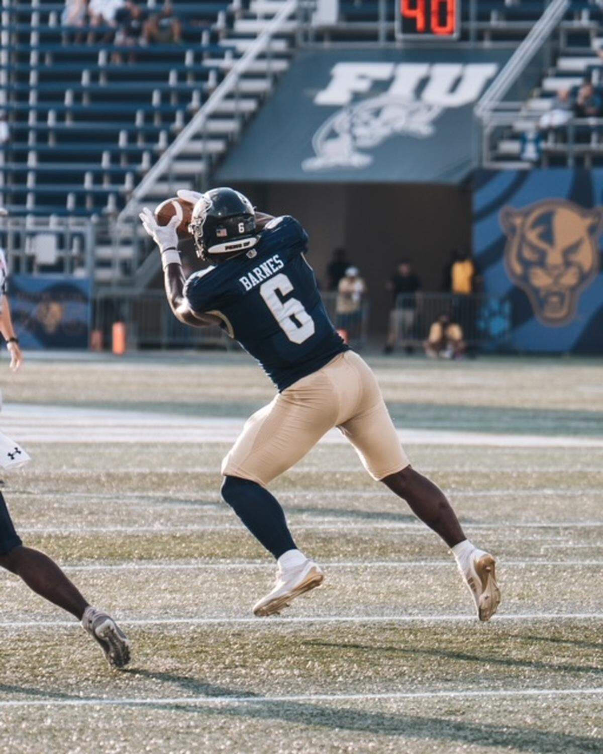 FIU linebacker Travion Barnes intercepts a pass during last Saturday’s loss to Monmouth at Pitbull Stadium.