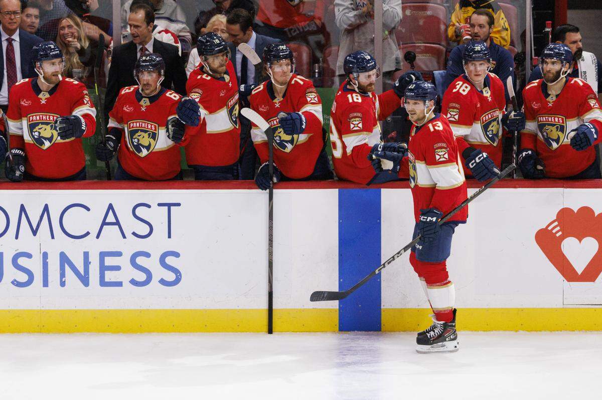 Florida Panthers center Sam Reinhart (13) high-fives teammates after scoring a goal during the second period of a game against the Toronto Maple Leafs on Tuesday, Dec. 2, 2025, at Amerant Bank Arena in Sunrise, Fla.