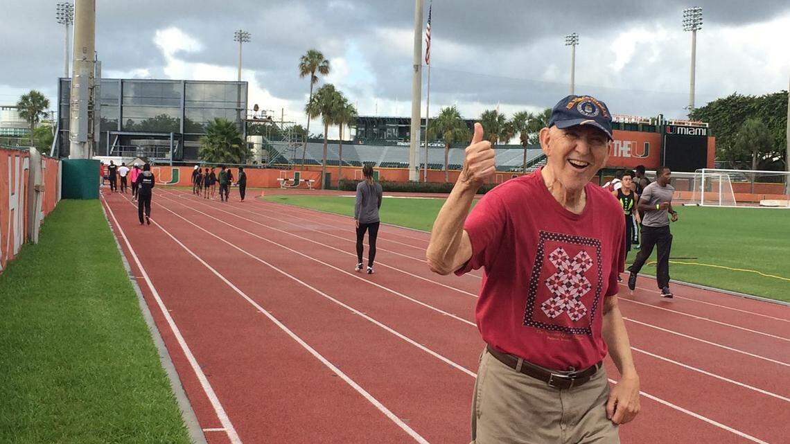 Sherwood Ross running on the track after son, Karl, finished a race.