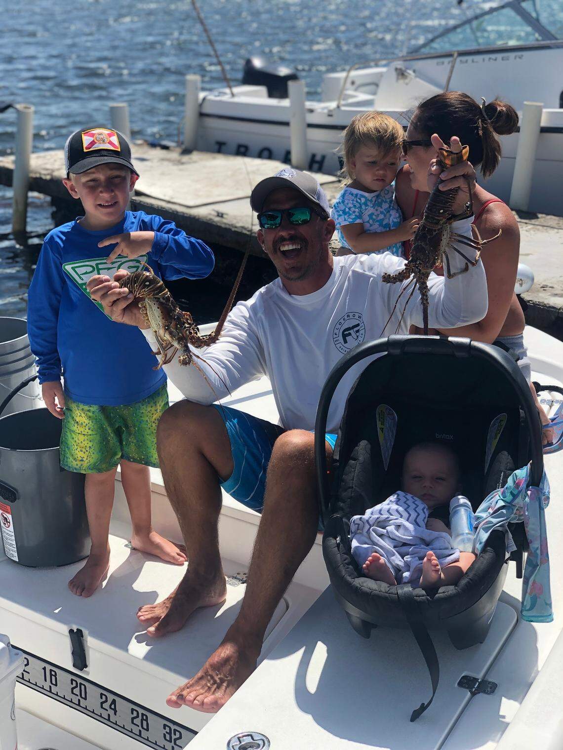 Justin Stuller and his wife, Kristen Stuller, are photographed with their children Henry, 5, Kinsley, 2, and 4-month-old Richard, on Wednesday, July 29, 2020. Later in the day, Justin Stuller was bitten by a lemon shark as he scuba dived for lobster off Stock Island.