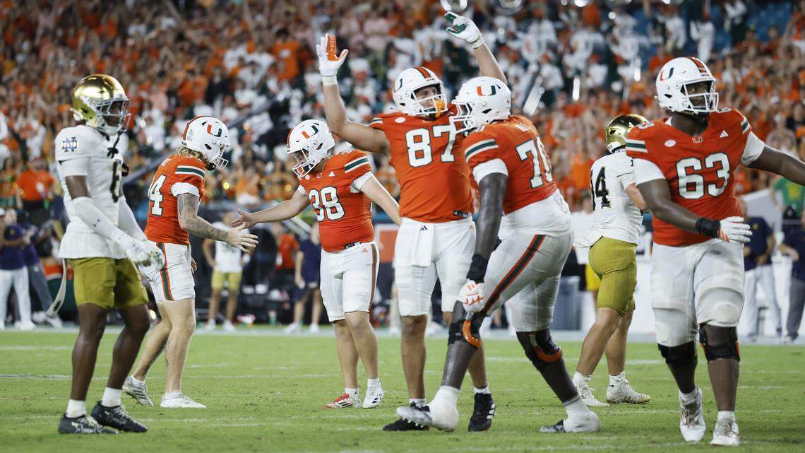 Miami Hurricanes kicker Carter Davis (38) celebrates with Dylan Joyce (94) after kicking the winning field goal in the fourth quarter during an NCAA football game against the Notre Dame Fighting Irish at Hard Rock Stadium in Miami Gardens, Florida, on Sunday, August 31, 2025.