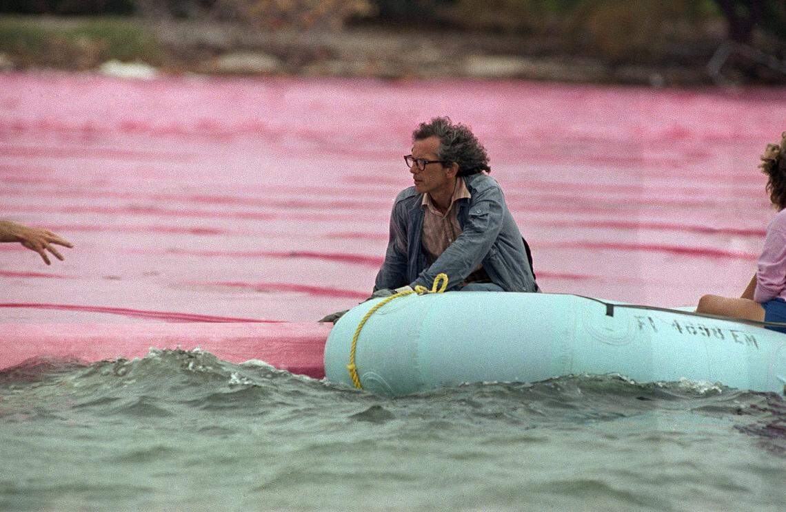 Artist Christo rides in an inflatable motorboat as he guides the installation of his 'Surrounded Islands' project in Biscayne Bay in May 1983.