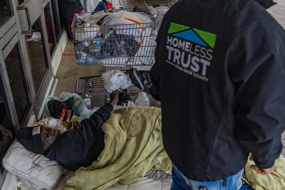 A man receives items donated by Florida Power & Light — including gloves, coats, socks and blankets — from City of Miami outreach teams who distributed cold-weather gear to those without shelter as frigid temperatures bore down on South Florida on Saturday, Jan. 31, 2026.