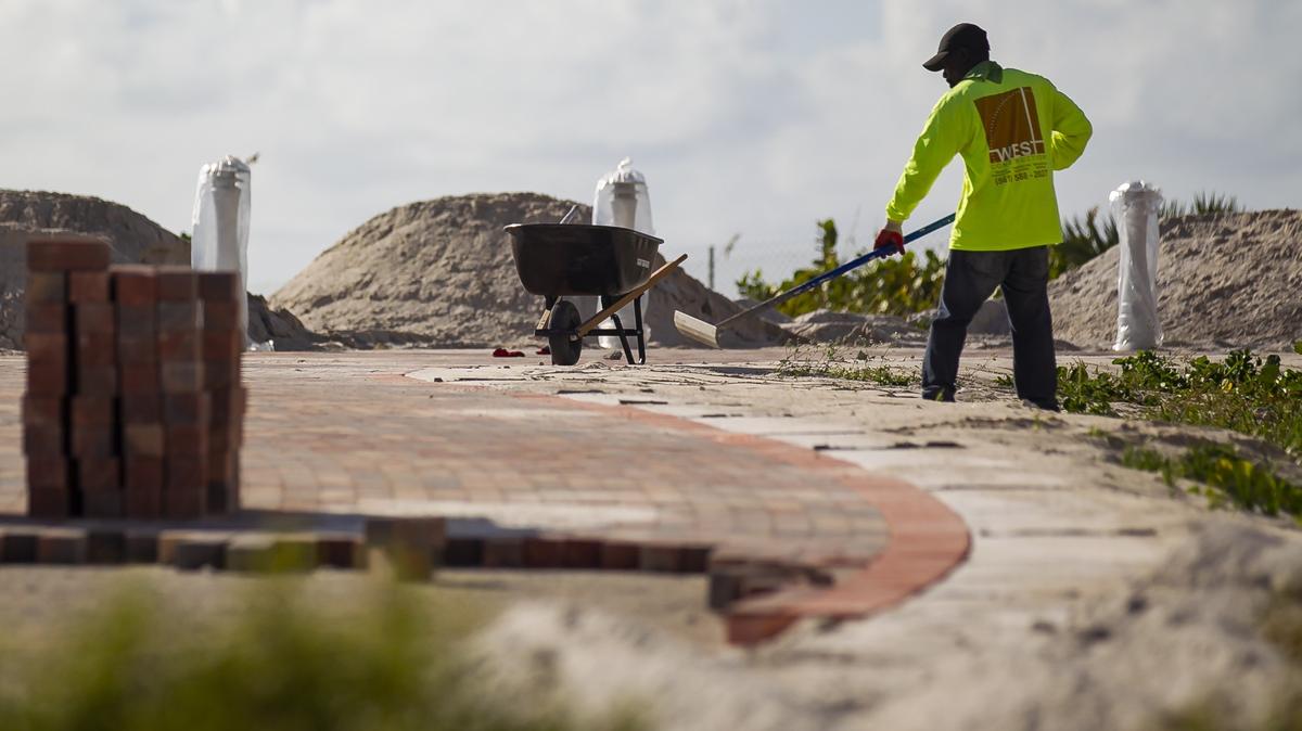 Workers build a path between Third Street and Fifth Street in South Beach on Friday, Nov. 2, 2018. Some residents worry that the construction will harm the dunes.