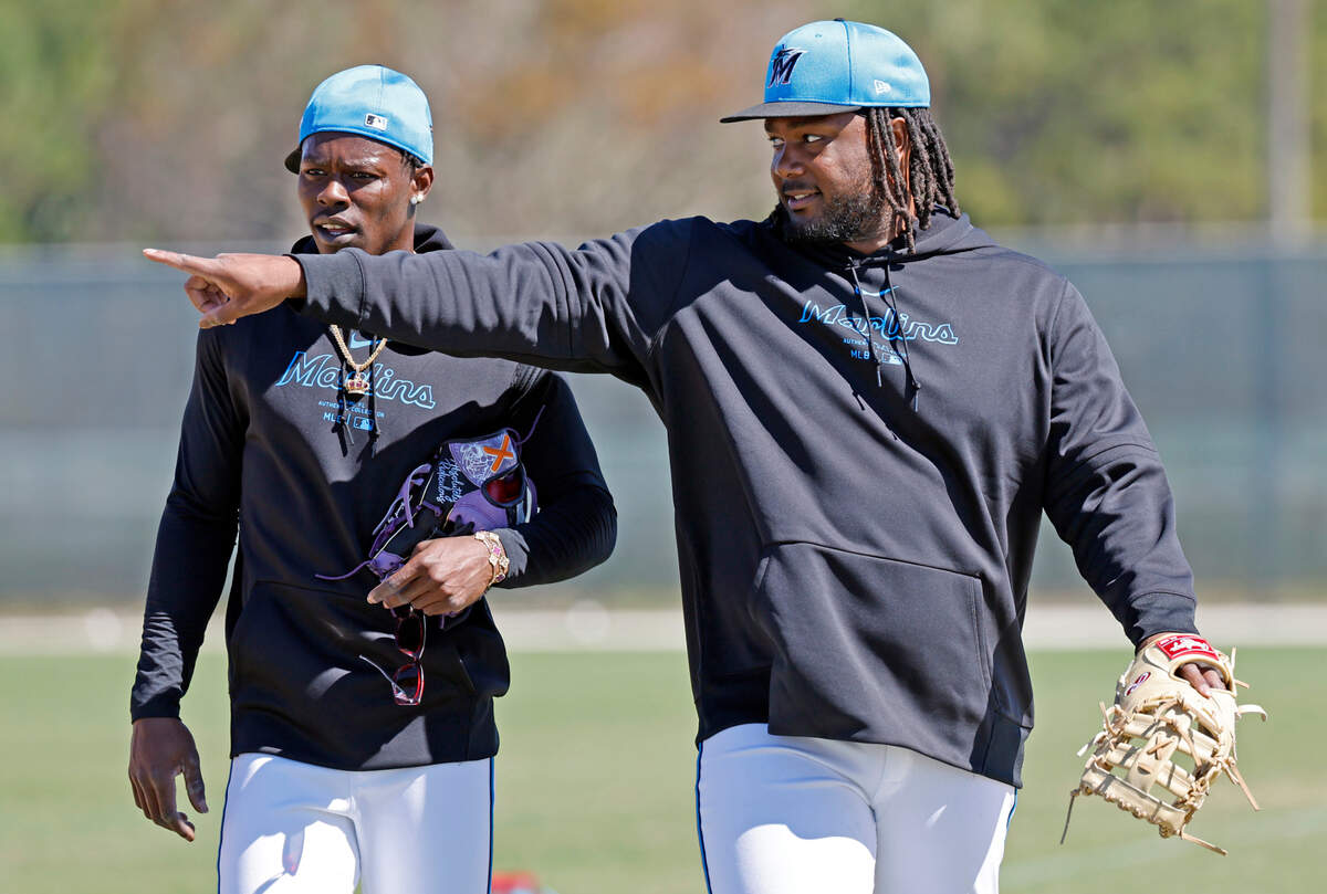 Miami Marlins first baseman Josh Bell (right) gestures as he walks off the field with teammate Jazz Chisholm Jr. during spring training at Roger Dean Chevrolet Stadium in Jupiter, Florida on Tuesday, February 20, 2024.