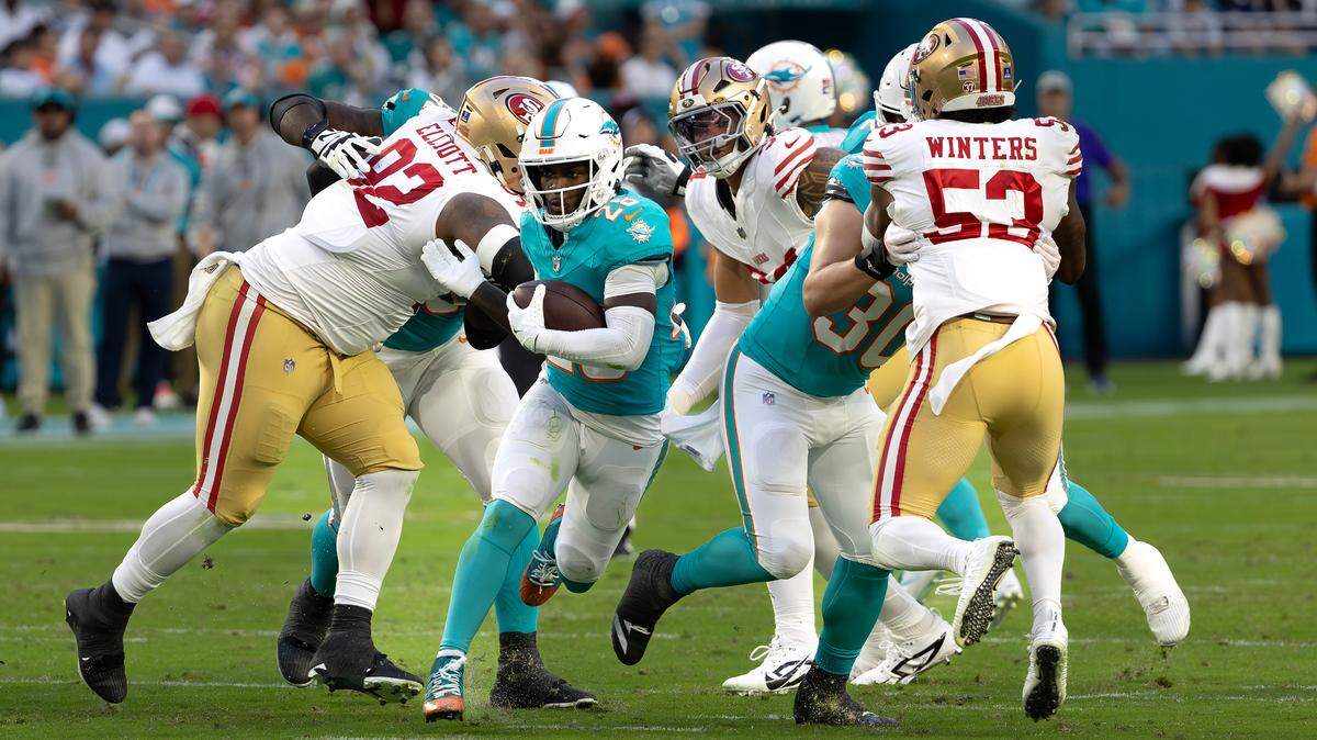 Miami Dolphins running back De’Von Achane (28) carries the football during the first half of their NFL game against the San Francisco 49ers at Hard Rock Stadium on Sunday, Dec. 22, 2024, in Miami Gardens, Florida.