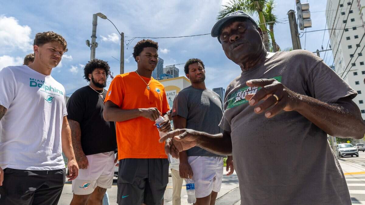 Dr. Marvin Dunn, a local American historian, gives a guided tour to the 2026 Dolphins rookie class on the streets of Overtown, Fla., on Monday, June 15, 2026. Players are learning about black history in celebration and recognization ahead of Juneteenth.