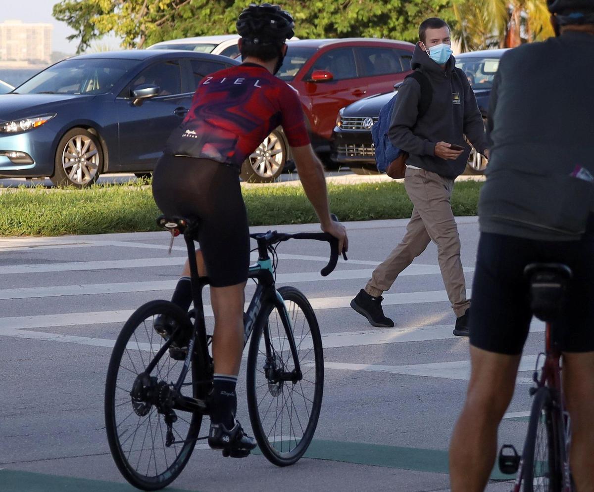 MAST Academy students walk toward campus as all elementary students plus students in grades 6, 9 and 10 go back for in-person learning Wednesday, Oct. 7, 2020. The school is off the Rickenbacker Causeway, a favorite roadway for many cyclists.