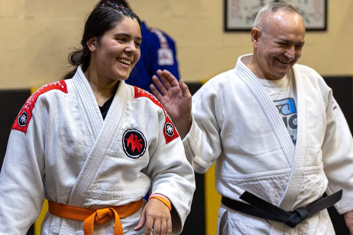 Braelen Cintron, 18, left, a judo student, and Alberto Fernandez, president of Baragua Judo Kai, laugh together at Baragua Judo Kai in Miami, Fla., on Wednesday, June 3, 2026.