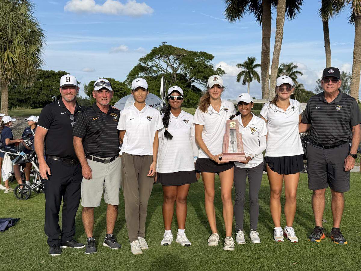 American Heritage’s girls’ golf team celebrates after winning the Region 4-2A championship at Pompano Beach Golf Club.