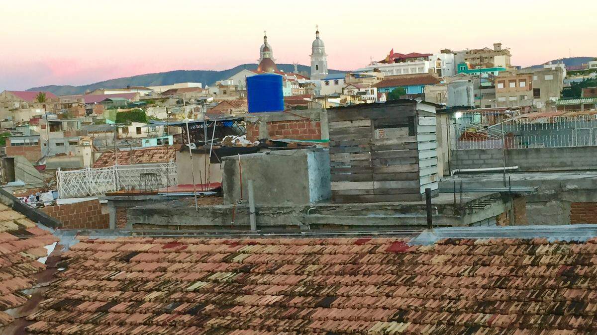 American Airlines plans to launch a direct daily flight from Miami to Santiago de Cuba, the largest city in eastern Cuba.  Here downtown Santiago can be seen in the distance from the rooftop of a home.