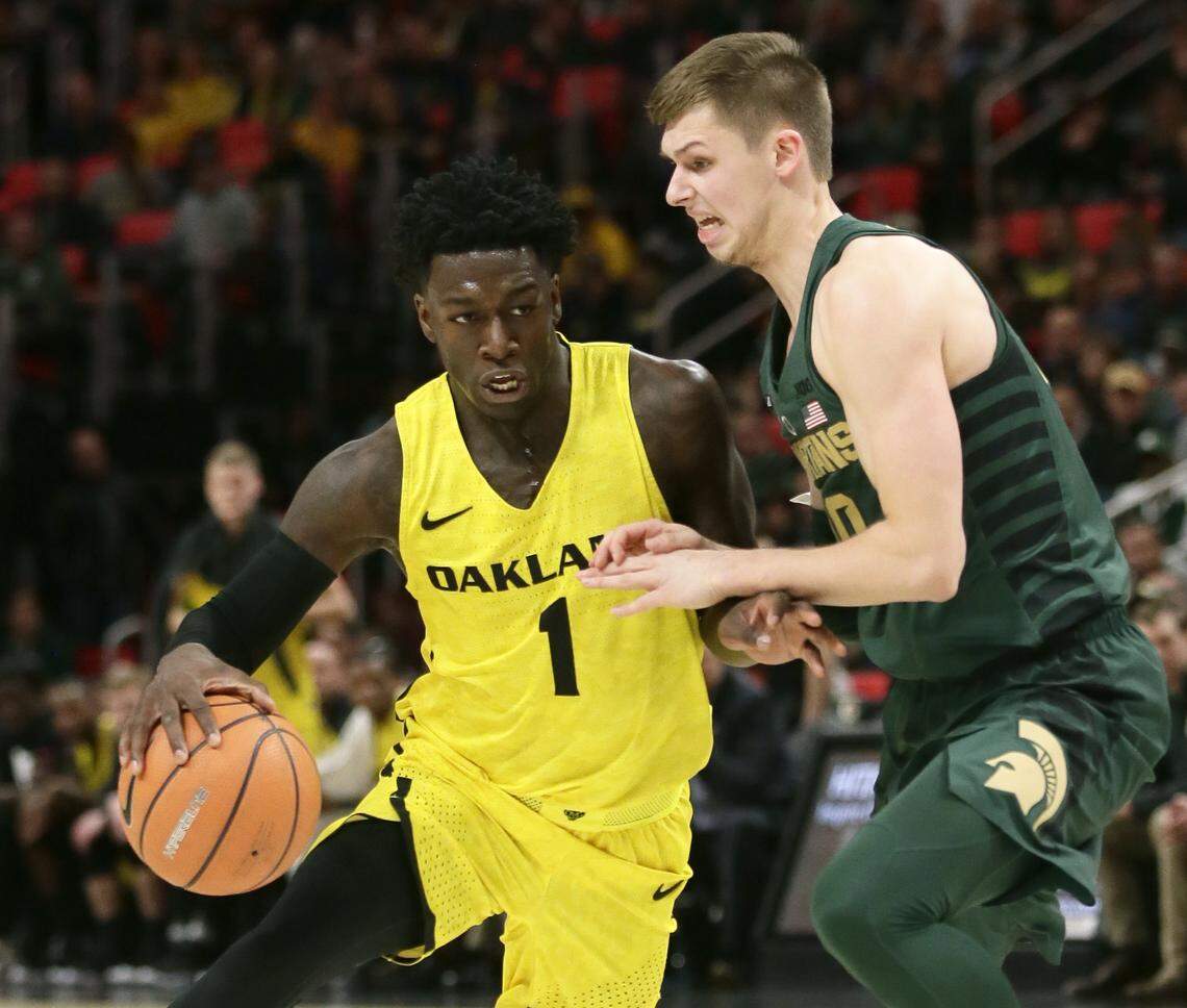 Oakland guard Kendrick Nunn (1) drives against Michigan State guard Matt McQuaid (20) during the first half of an NCAA college basketball game Saturday, Dec. 16, 2017, in Detroit. (AP Photo/Duane Burleson)