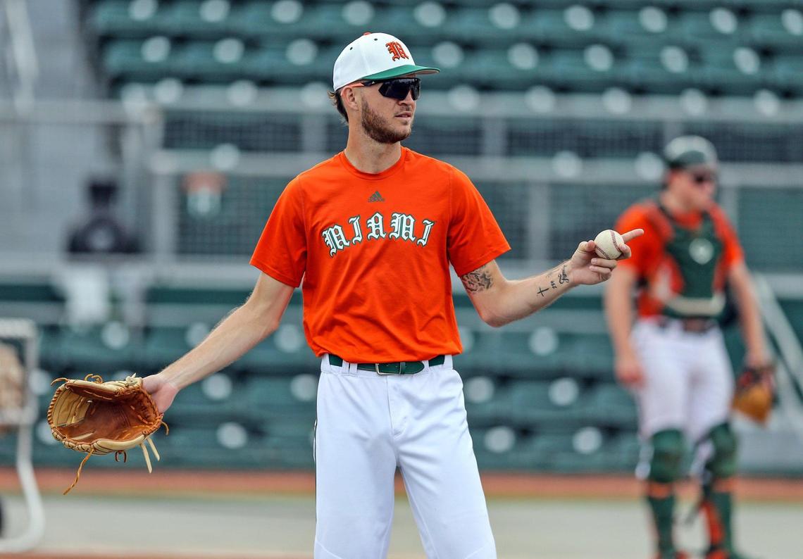 Miami Hurricanes pitcher Carson Palmquist tosses the ball at practice at the University of Miami’s Alex Rodriguez Park at Mark Light Field in Coral Gables on Monday, February 14, 2022.
