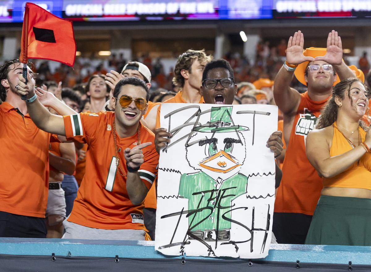 Miami Hurricanes fans cheer for their team as they play against the Notre Dame Fighting Irish in the first half of their NCAA football game at Hard Rock Stadium on Sunday, Aug. 31, 2025, in Miami Gardens, Fla.