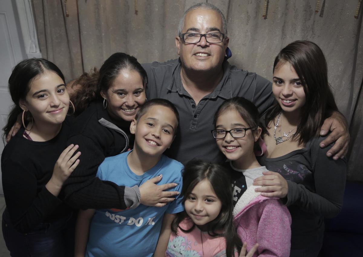 Zenaida Soto and Lenoel Garcia, center, do what they can to provide for their families. But health problems and an electrical fire have made the holidays tough this year for them and their kids, clockwise, left to right: Barbara Garcia, 14 , Marceline Garcia, 16, Yolievette Garcia, 10, Yanislacey Garcia, 7, and Leonel Garcia, 12.
