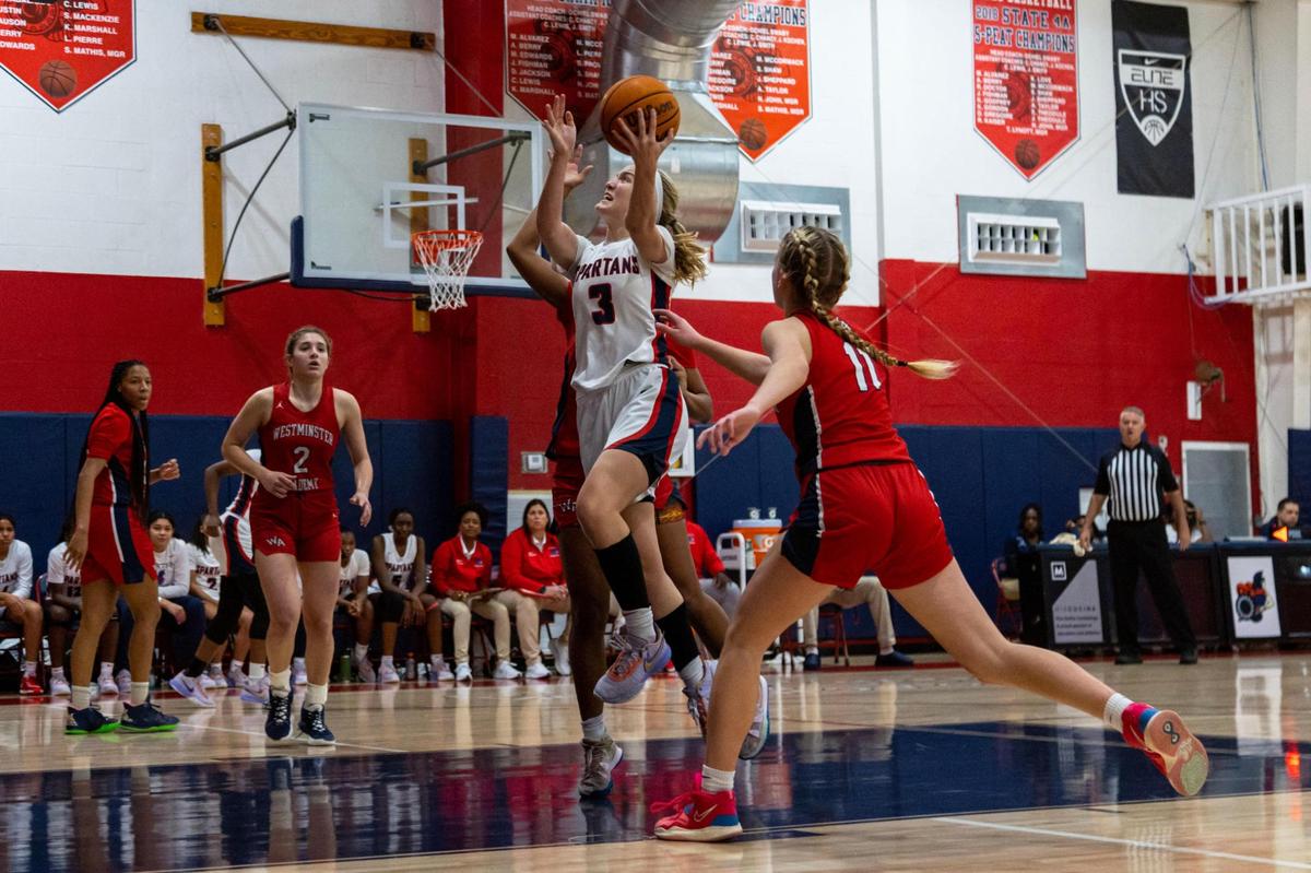 Miami Country Day’s Kristina Godfrey (3) drives through the lane while guarded by Westminster Academy defenders Markeli Jones-Tynes (1) and Maddie Wallhoff (11) during the Region 4-3A girls basketball final in Miami, Florida, on Friday, February 17, 2023.