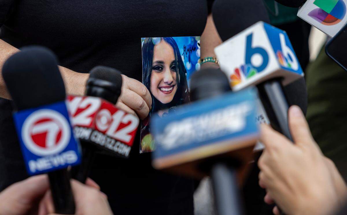 Lori Alhadeff holds a picture of her daughter, Alyssa, as she speaks to members of the media as crews use heavy equipment to tear down the 1200 building of Marjory Stoneman Douglas High School on Friday, June 14, 2024, in Parkland, Fla. Alhadeff’s 14-year-old daughter, Alyssa, was among the 17 people who died in the February 14, 2018, mass shooting at the school.