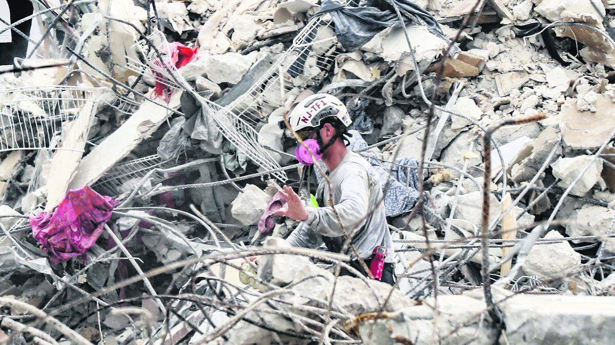 A search-and-rescue team member in the debris field of the Champlain Towers South in Surfside on July 7, 2021.