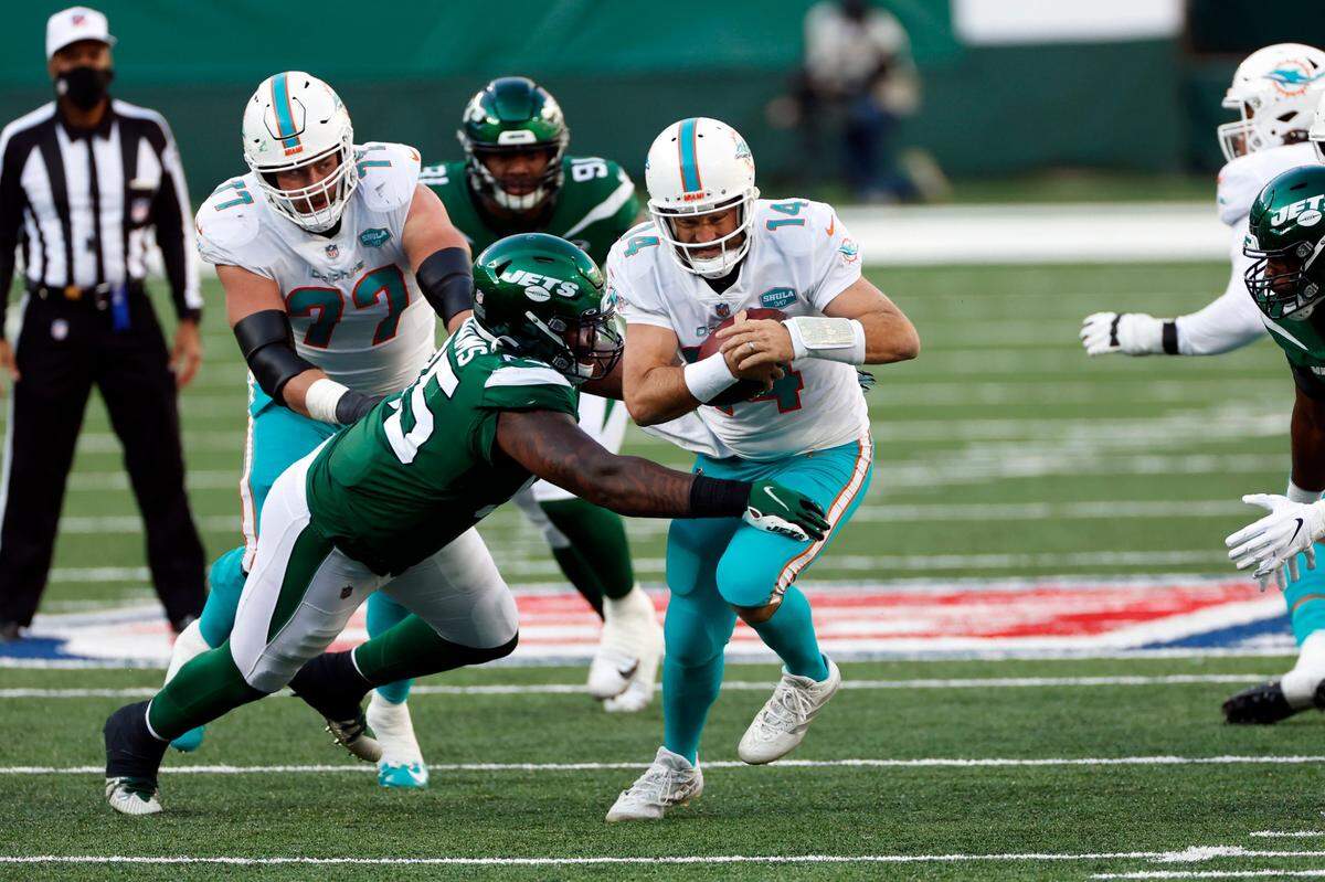 Miami Dolphins quarterback Ryan Fitzpatrick (14) rushes during an NFL football game against the New York Jets, Sunday, Nov. 29, 2020, in East Rutherford, N.J. (AP Photo/Adam Hunger)