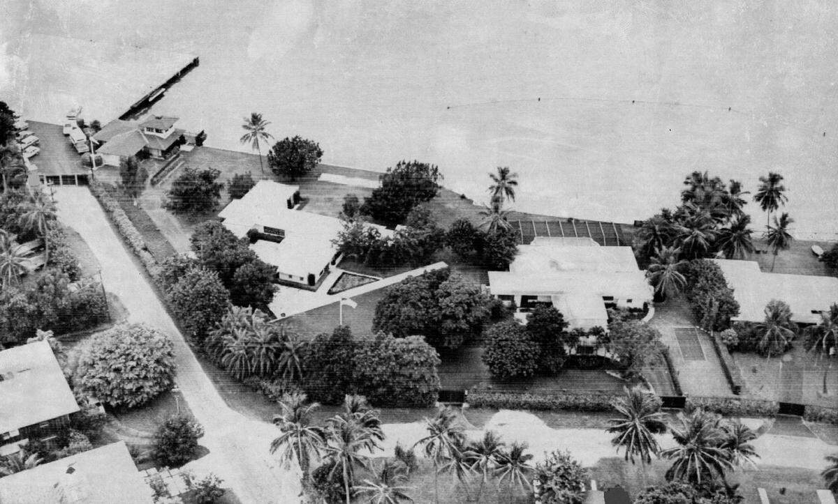 This 1974 view shows the three homes one occupied by former President Richard Nixon on Key Biscayne. Behind his home with covered swimming pool is the shark net, in Biscayne Bay. Top left is his helipad. Home adjacent to helipad was used to house Secret Service personnel. 