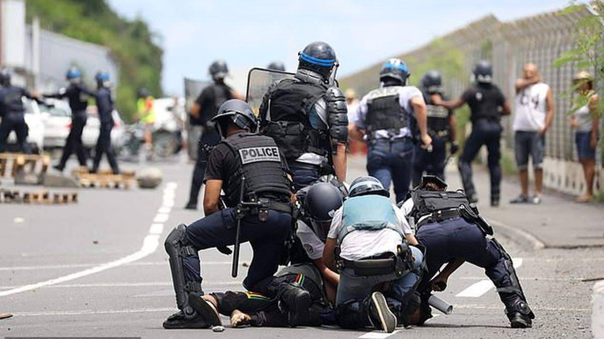 French police subdue protesters who don’t want a cruise ship to dock in Reunion Island, in the Indian Ocean, for fear passengers might have the coronavirus.