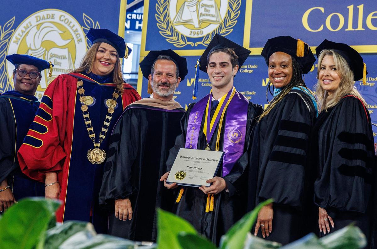 Student Raul Rivero received the MDC Board of Trustees Scholarship from President Madeline Pumariega (second from left) and Board of Trustees members including Chair Michael Bileca, during Miami Dade College’s North, Hialeah and West Campuses 2025 commencement ceremonies at LoanDepot Park, in Miami on Saturday, April 26, 2025.