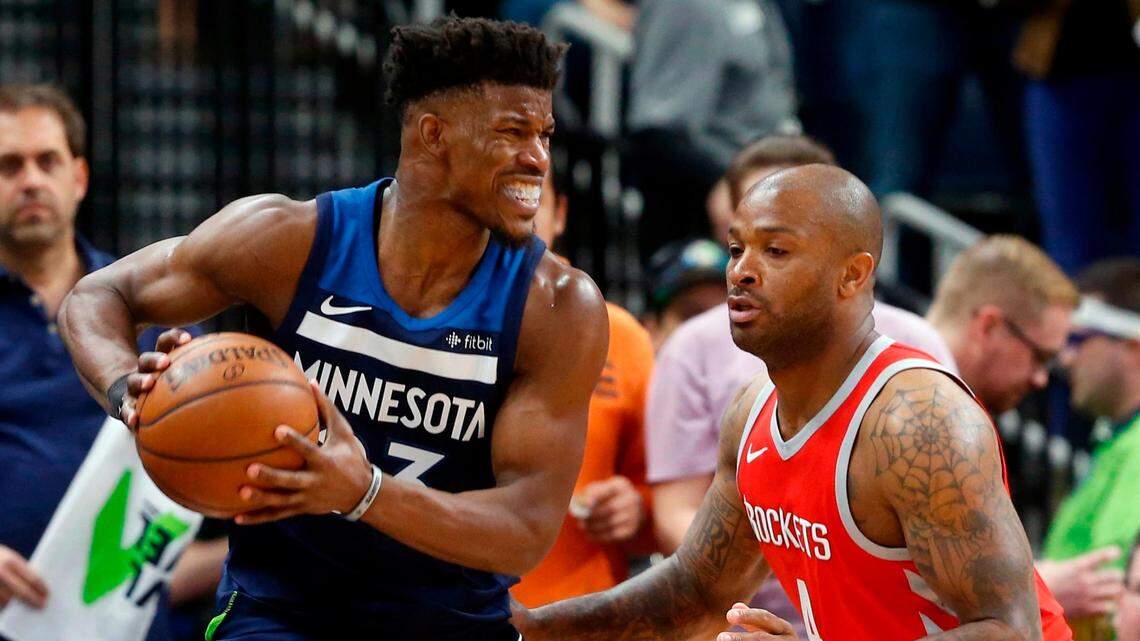 Minnesota Timberwolves’ Jimmy Butler, left, keeps the ball close as Houston Rockets’ PJ Tucker defends during a playoff game in April.