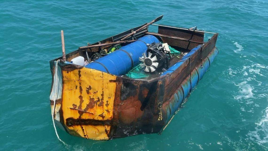 A rustic vessel floats in the ocean off the Florida Keys Saturday, April 10, 2021. The U.S. Coast Guard said 14 people from Cuba were onboard the boat when the agency’s crews encountered it.