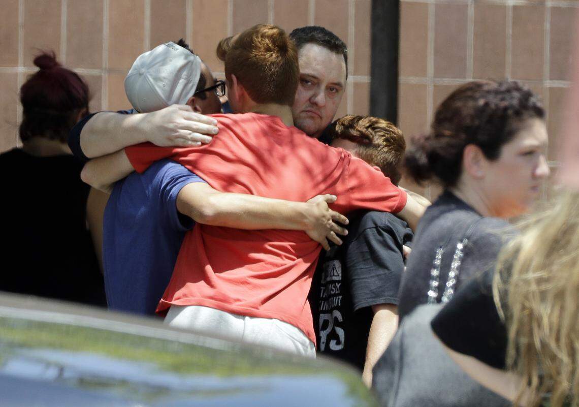 People react outside the unification center at the Alamo Gym, following a shooting at Santa Fe High School Friday, May 18, 2018, in Santa Fe, Texas.