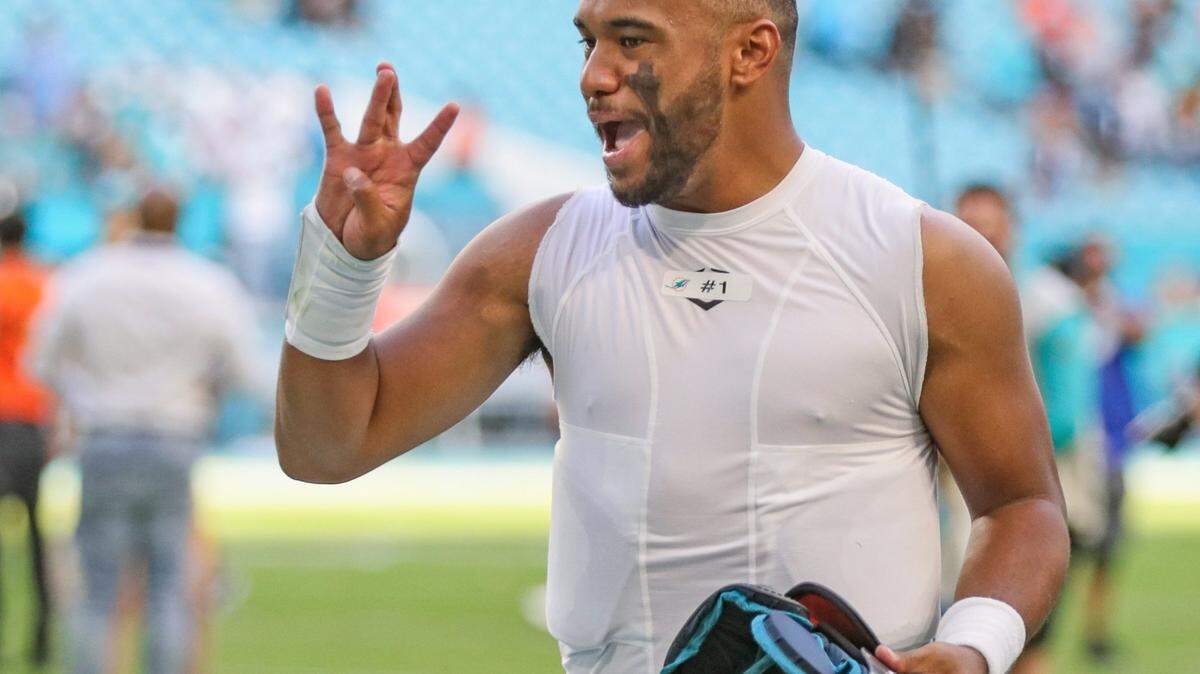 Miami Dolphins quarterback Tua Tagovailoa (1) gestures coming off the field after the Dolphins defeat the Carolina Panthers at Hard Rock Stadium on Sunday, November 28, 2021.