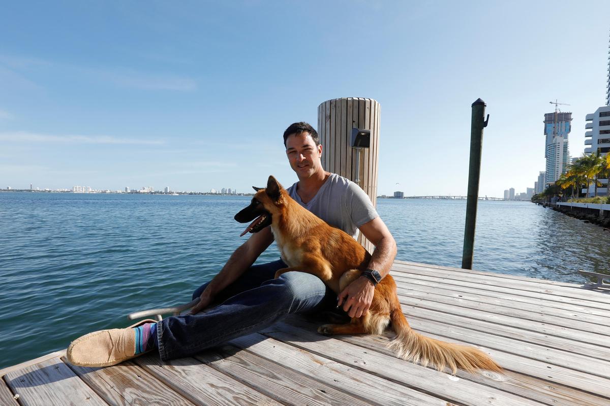 Rian Maercks’ dog Schiele was taken from his car two years ago. Maerks recently reunited with the pup after it showed up at Miami-Dade Animal Services. Pictured, Maercks holds Schiele Nov. 26, 2019, outside his Edgewater condo building.