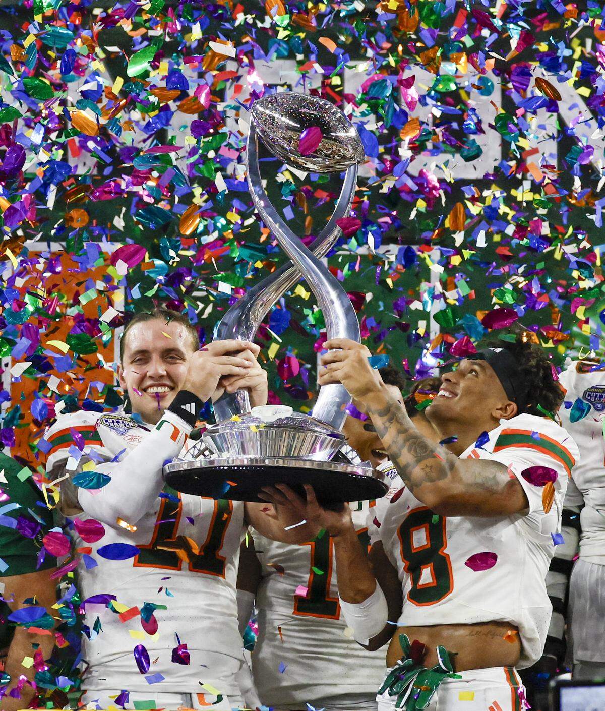 Miami Hurricanes quarterback Carson Beck and safety Jakobe Thomas celebrate after a College Football Playoff quarterfinal win over the Ohio State Buckeyes in the Cotton Bowl at AT&T Stadium in Arlington, Texas on Wednesday, December 31, 2025.