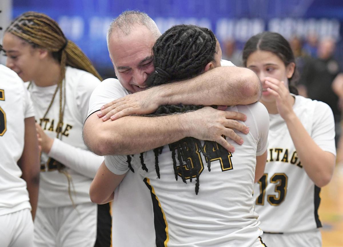 American Heritage head coach Greg Farias hugs game-high scorer Jasleen Green (34,) who had 27 points against Mainland in the Class 5A final during the Florida High School State Championships at the RP Funding Center in Lakeland, Fl on Friday March 8, 2024. American Heritage defeated Mainland 60-55 to win the Class 5A State Title. Scott Wheeler | Photo