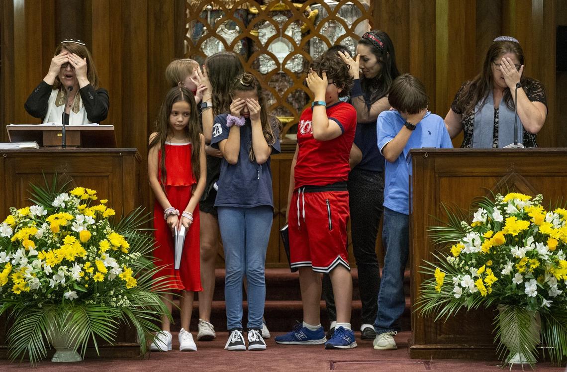 Children cover their eyes during Shema prayer at Shabbat services at Temple Israel of Greater Miami on Friday, Sept. 20. Rabbi Amy Morrison, at right, is the temple’s new senior rabbi. This will be her first Rosh Hashana at Temple Israel.