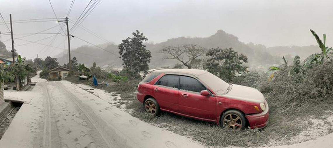 This April 10, 2021, handout image courtesy of the UWI Seismic Research Center shows a car and road covered in ash after the April 9 eruption of the La Soufriere Volcano. La Soufriere erupted for the first time in 42 years on the Caribbean island of Saint Vincent, prompting thousands of people to evacuate, seismologists said.