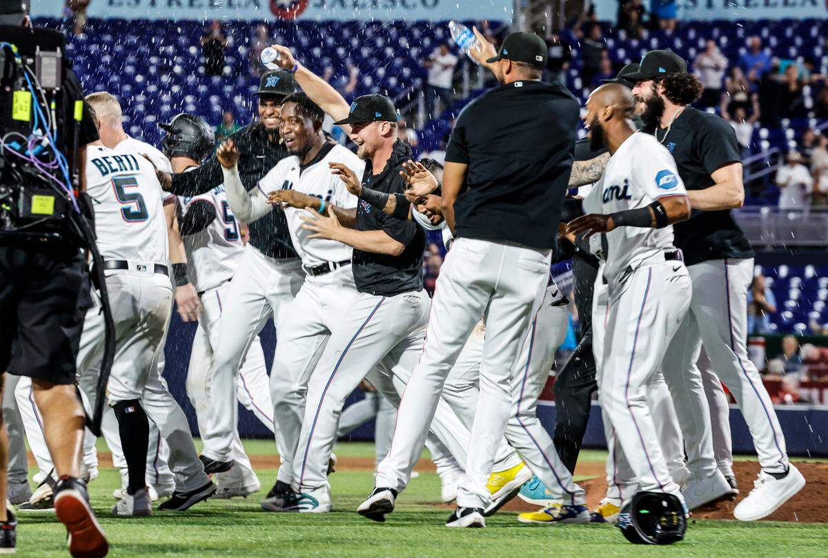 Miami Marlins celebrate on the infield after defeating the St. Louis Cardinals at loanDepot park in Miami on Wednesday, July 5, 2023.