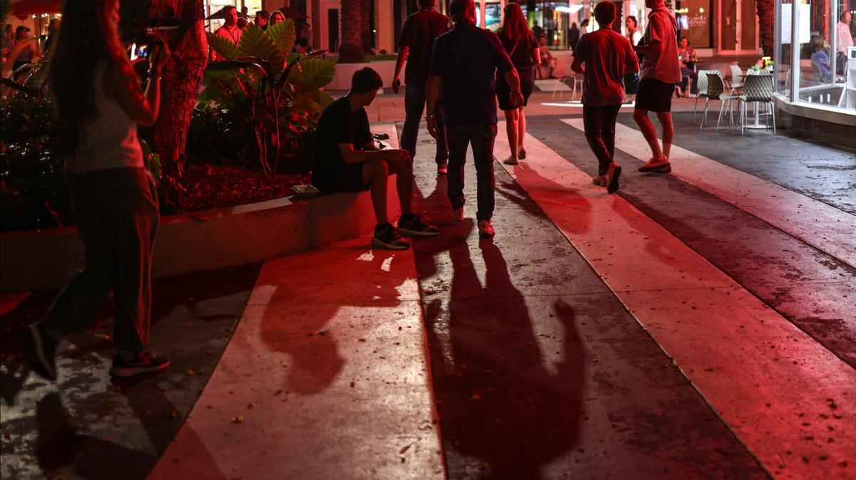 A homeless canvassing team exits a dark section of Lincoln Road Mall on Aug. 22 in Miami Beach while attempting to count the unsheltered population.